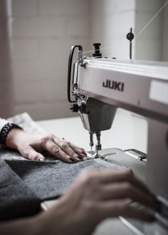 a person using a sewing machine to sew something