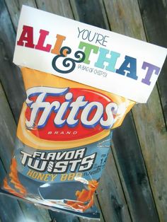 a bag of fritos sitting on top of a wooden fence