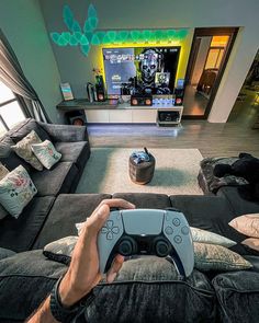 a man is playing a video game in his living room