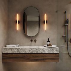 a bathroom with a sink, mirror and shower head in it's center area