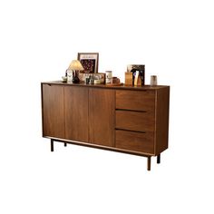 a wooden cabinet with two lamps and pictures on it's sideboard, against a white background