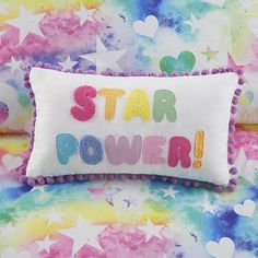 a pillow with the words star power written on it and hearts all over it in rainbow colors