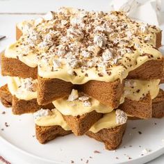 a white plate topped with brownies covered in frosting