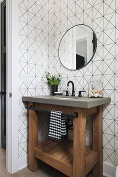 a bathroom with a sink, mirror and towel rack in front of the counter top