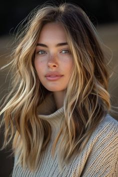 Portrait of a young woman with sun-kissed freckled skin and tousled blonde hair wearing a cozy sweater. Blonde Highlights Shag Hair, Light Hair Dark Eyebrows, Brunette Summer Hair Color, Brunette Summer Hair, Summer Hair Color Ideas, Brunette Balayage Hair, Balayage Brunette