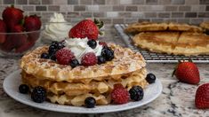 some waffles and strawberries on a table