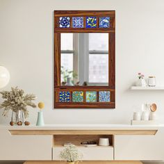 a wooden window with blue and white tiles on the windowsill in a living room