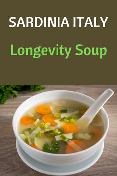 a white bowl filled with soup on top of a wooden table