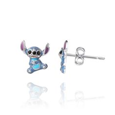 a pair of earrings with an image of a cartoon character on the front and back