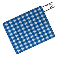 a blue and white checkered placemat with a black metal hook on it's side