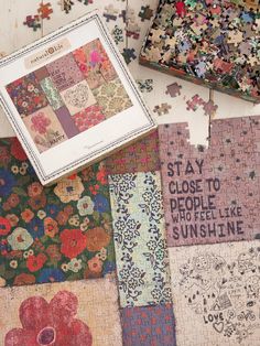 several pieces of puzzle on the floor with words written on them and flowers in different colors