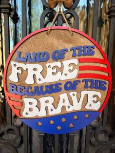 a sign that says land of the free because of the brave on it's front gate