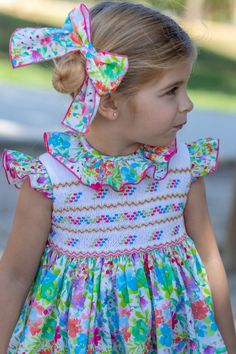 Elevate your little one's summer wardrobe with the Stunning Girls Multi-Coloured Print Smocked Summer Dress by Naxos for SS24—a captivating ensemble meticulously crafted in Spain. This dress showcases a delightful and vibrant multi-coloured print, embodying the charm and sophistication synonymous with Spanish children's wear. The smocked detailing adds an extra touch of elegance, making it a perfect choice for warm-weather occasions. Secure her size online now and be among the first to welcome t Smocked Flower Girl Dress, Baby Knitwear, Spanish Fashion, Boys Set