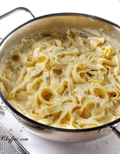 a pot filled with pasta on top of a stove