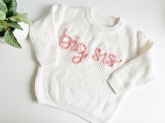 The perfect big sister gift! Sample shown is a sweater in cream with pink rose embroidery.  Big brother sweater here: https://www.etsy.com/listing/1710502447/big-brother-sweater-big-bro-sweater-baby?click_key=fcae6f62a8745508a07fa3f7205b9510004938d5%3A1710502447&click_sum=49b64b76&ref=shop_home_active_10&pro=1&frs=1 *If you're looking for a specific sweater or yarn color, please send me a message and I can source it for you. TO ORDER -Select size and sweater color via the drop down menus -In the personalization box, leave embroidery color SIZING AND FIT -All sweaters are an OVERSIZED fit, perfect for watching baby grow throughout their first year, layering, or having a long lasting, heirloom piece. If you'd like a more snug fit, order a size down. WASHING INSTRUCTIONS: Turn sweaters inside Leave Embroidery, Baby Announcement Big Sister, Baby Jumpers, Sister Announcement, Big Sister Announcement, Big Sister Gifts, Pull Bebe, Sister Shirt, Big Sister Shirt