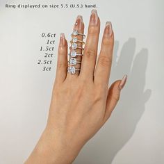 a woman's hand with five different rings on her finger and the size chart for each ring