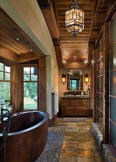 a bathroom with a large tub in the middle of it and wood paneling on the walls