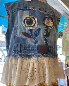 a denim jacket with patches and flowers on it