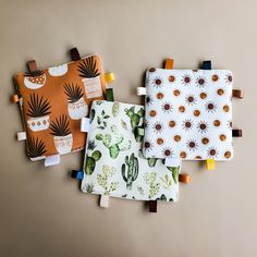 three pot holders with cactus designs on them, one is orange and the other is white