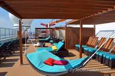 an outdoor lounge area on the deck of a cruise ship with chairs and hammocks