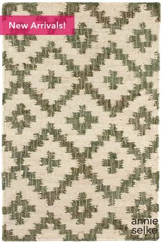 an old rug with green and white designs on it, next to the words new arrivals