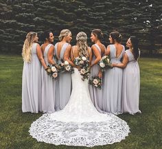 a group of women standing next to each other on top of a lush green field