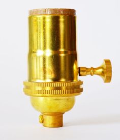 a gold colored metal object on a white background