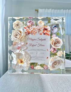 a clear acrylic frame with flowers on it