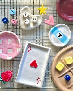 some clay toys are sitting on a wire rack and one is shaped like a board game