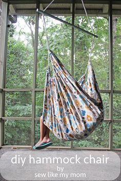 a woman laying in a hammock on top of a window sill