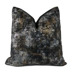 a black and grey pillow with an abstract design