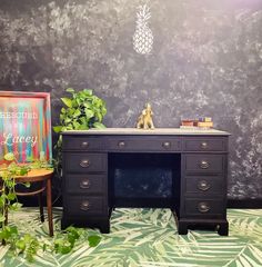 a desk and chair in front of a wall with a pineapple sign on it