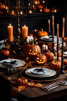 a table set for halloween with pumpkins and candles