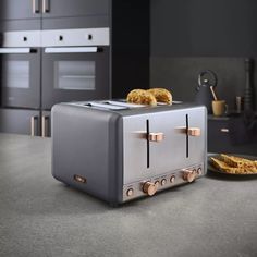 a toaster sitting on top of a counter next to a plate with food in it