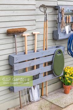 an outdoor garden with gardening tools and flowers