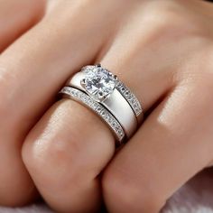 a woman's hand with two wedding rings on top of her finger and the other ring