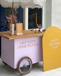 an ice cream cart is decorated with pink and yellow