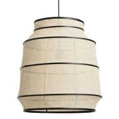 a light hanging from a ceiling fixture with a white and black stripe pattern on it