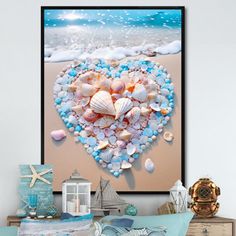 a heart made out of seashells on the beach