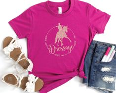 This Kids Dressage Horse shirt is perfect for a young horse girl! A great look for at a dressage horse show or around the barn. Kids will love this custom youth short sleeve tee. This lightweight side-seamed shirt maximizes comfort all day long. Side seams keep the garment's shape. The shoulders have tape for longer fitting. The collar is extra elastic due to ribbed knitting.  .: 100% Airlume combed and ringspun cotton (fiber content may vary for different colors) .: Extra Light Fabric  I can ac Equestrian Shirt, Equestrian Girls, Dressage Horses, Horse Shirt, Horse Girl, Show Horses, Kids Shorts, Custom Artwork, Dressage