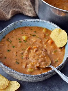 a bowl of soup with tortilla chips on the side