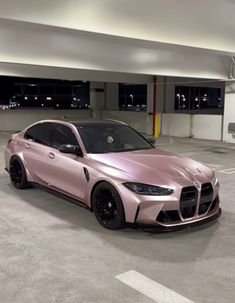 a pink sports car parked in a parking garage