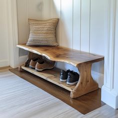 a pair of shoes are sitting on a wooden bench in front of a white wall