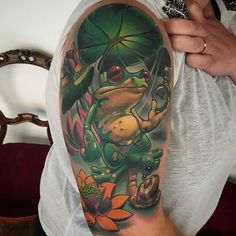 a man with a frog tattoo on his arm