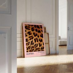 a leopard print is on the floor in an empty room with white walls and parquet floors