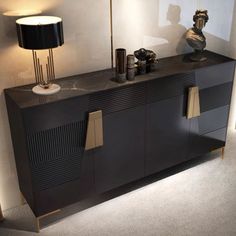 a black sideboard with two lamps on it