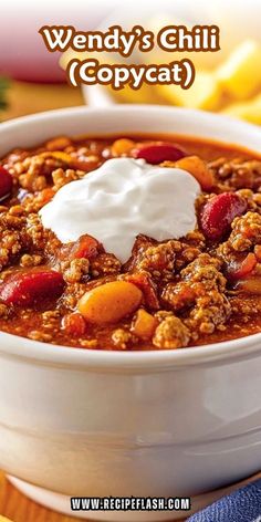 a close up of a bowl of food on a table with the words wendy's chili copycat