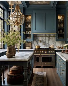 a kitchen with blue cabinets and marble counter tops, an island in front of the stove