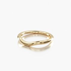 a yellow gold ring with curved edges and a thin band in the middle, against a white background