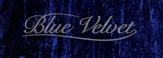 the word blue velvet written in white ink on a dark background with trees and grass